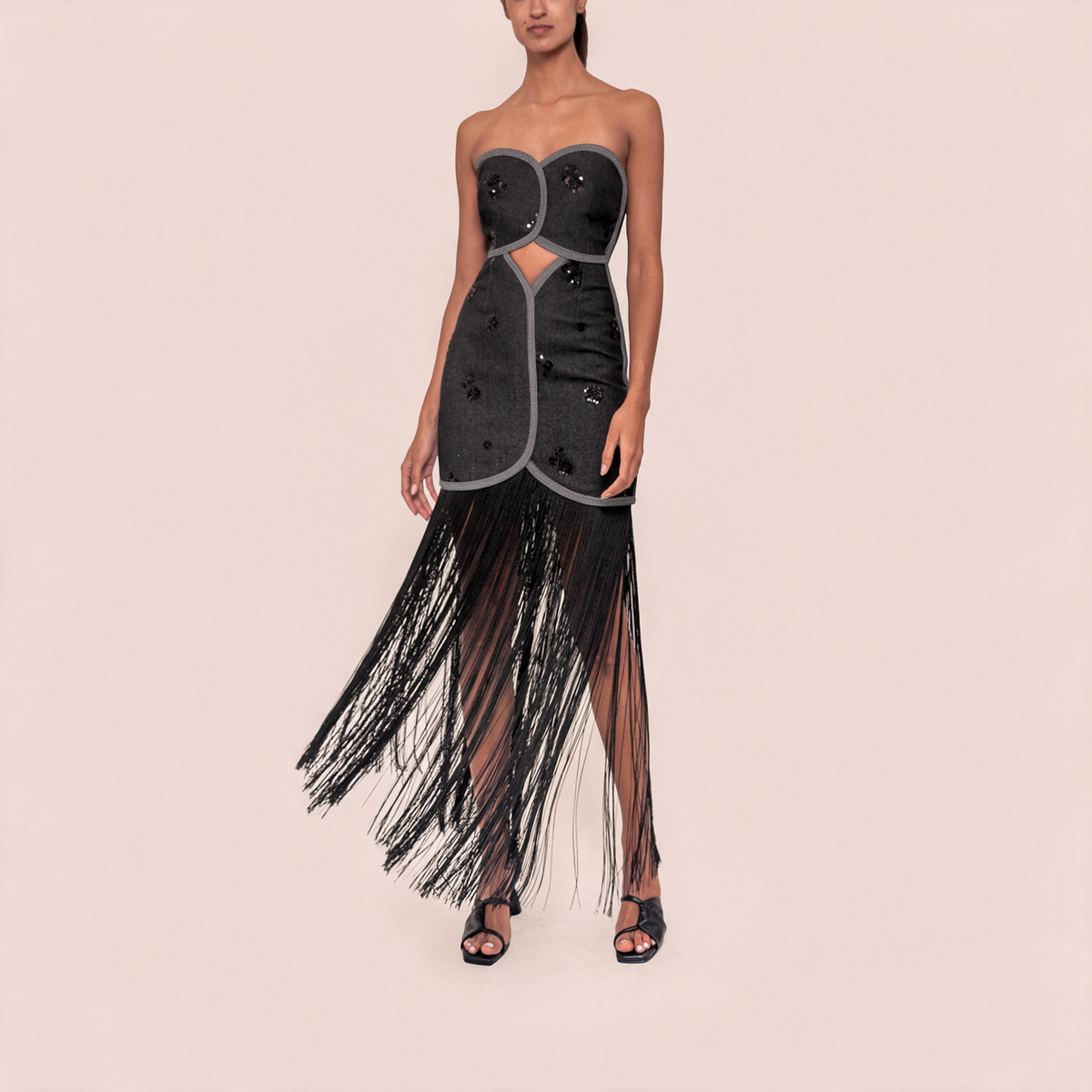 Strapless black denim-look dress with fringe hem and circular patchwork bust detailing