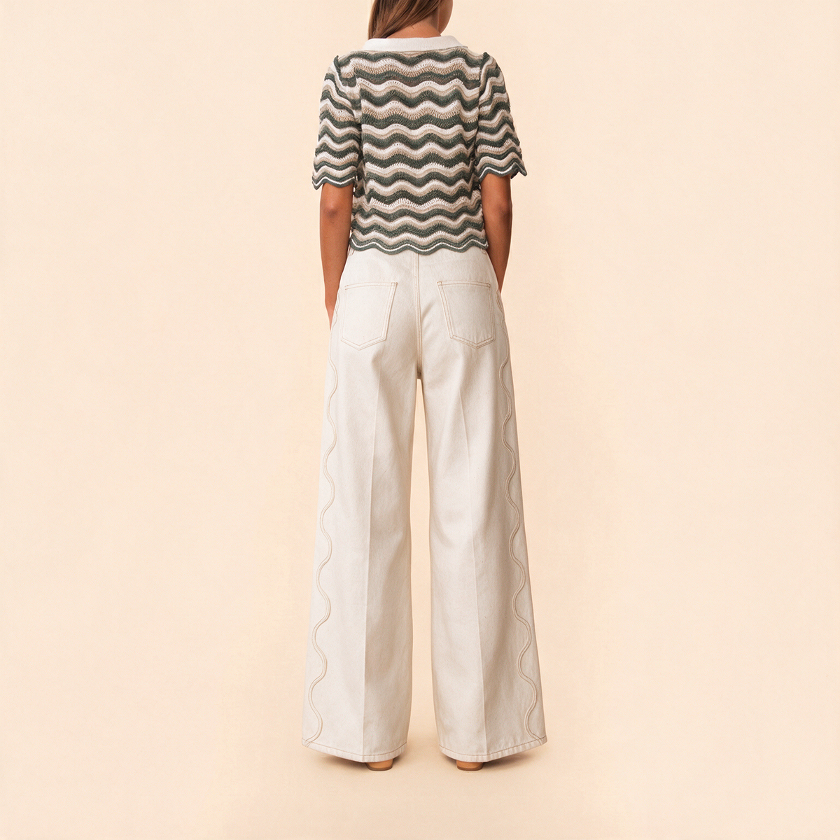 MALAI ivory wide-leg jeans, back view with wavy side seam stitching and patch pockets